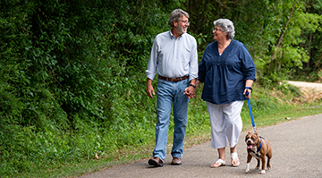 Photo of Louis and Tawnya Fitzmorris walking their dog